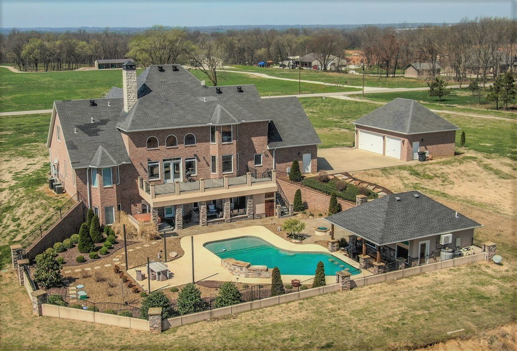 Welcome to your dream home!!! This stunning 6 bed, 5 ½ bath home sits on 9.9 acres with a country feel while still being close to town. The resort style backyard is designed for entertaining; featuring large heated pool, hot tub, multiple lounge areas both covered & open, outdoor gas fireplaces, beautiful pool waterfall, pool house currently used as a workout facility, an outdoor kitchen w/ swim up bar & a huge 2nd story balcony overlooking this backyard oasis.