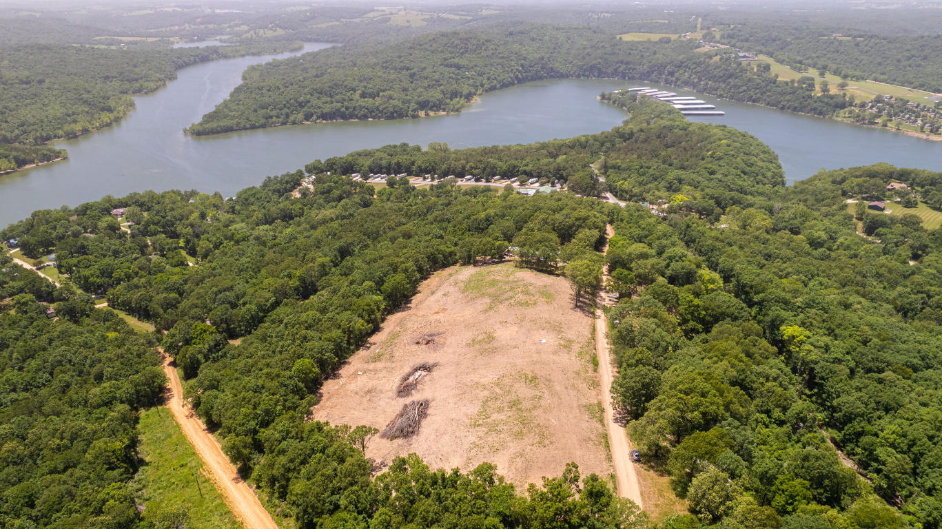 Stunning views of Table Rock Lake. Half acre build site with access to rural water and electricity. No restrictions on short term rentals. 20 minutes from Branson and 2 minutes from Cricket Creek Marina. Great build location for investment property or vacation home, and eligible for tiny home builds. Bring your own build plans or take over the custom plans that have already been designed for this lot.