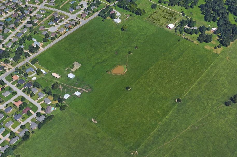 Excellent Development Opportunity! 37.59 Open, Level Acres in a great location along Honeysuckle Lane. Water runs to the front of the property along Honeysuckle. The closest sewer is at Nelda & Rogers Ave. just south of property. Buyer would need to verify sewer hookup. There is a house and outbuilding that is currently being rented on the south corner of the property. Survey has been completed.