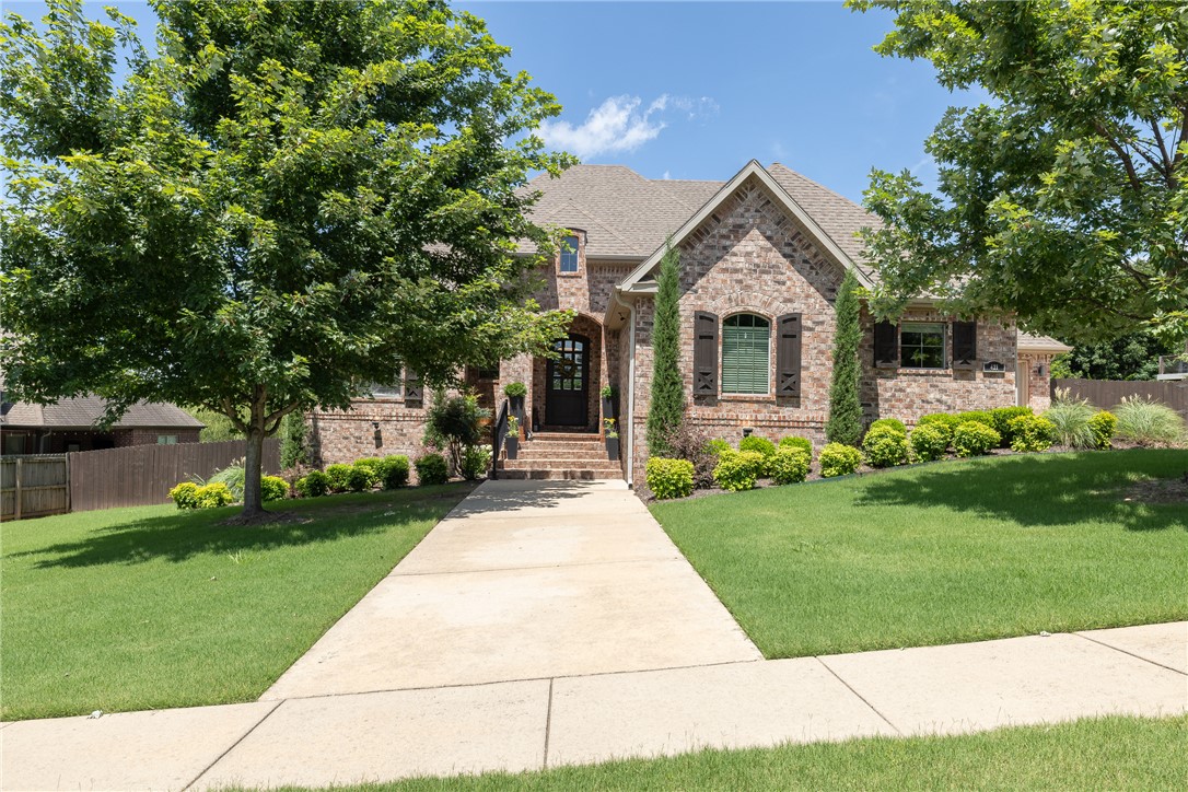 Stunning home on one of the largest lots in Stone Mountain! This exceptional property offers 4 bedrooms, 3.5 baths, an office, bonus room, formal dining, and a spacious living room with vaulted ceilings, wood beams, fireplace, and large windows overlooking the backyard. The gourmet kitchen features granite countertops, abundant cabinetry, double ovens, and a built-in wine fridge. Beautiful hardwood floors, central vacuum, security system, whole-house generator, and a large utility room add comfort and convenience. Step outside to the oversized covered deck with an outdoor fireplace and enjoy the huge fenced backyard, perfect for entertaining or relaxing. Additional features include a 3-car garage and countless quality details throughout. Ideally located in Stone Mountain, just minutes from the University of Arkansas, shopping, dining, and all that Northwest Arkansas has to offer!