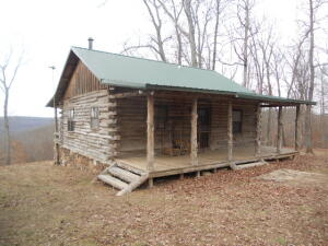 Cabin in the woods?  National Forest on 2 sides.  2BR 1BA log cabin with 37 acres, comes fully furnished, set up to sleep 6 comfortably.  you will love the wood stove, open floor plan, covered porches on the front and rear.  Breathtaking view from the back porch across the National Forest.  Seller is leaving all deer stands and feeders, property is move in ready and ready for new owners.  Owner has killed deer, bear, and turkey off the property.  This type is hard to find.