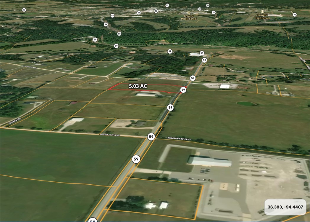 Level, Open 5.03 Acres with 328' highway frontage along Highway 59, 9000 VPD. The site is located in Benton County, one mile outside Gravette's downtown core. Parcel sits among dense commercial and industrial existing businesses.  Buyer to conduct own due diligence with Benton County on Conditional Use, Buyer to conduct own due diligence to verify utilities.