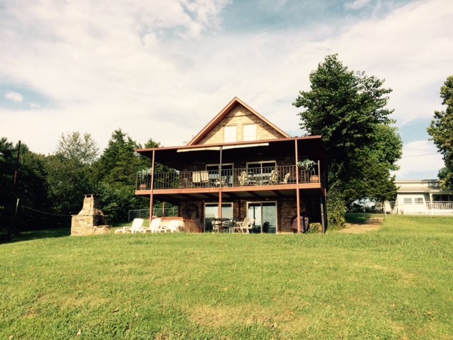 Beaver Lake Front Executive House 6 BR/3BA. This vacation rental house we are changing to long term rental with at least a year lease for the right family or professionals. Furnished with everything you need from cookware to furniture! Lake front with 2 covered decks with great views, hot tub and out door fireplace.Great views and great location. Easy commute back into town! Any potential renter will have to pass a credit check. $1250 per month with one month deposit, plus utilities.