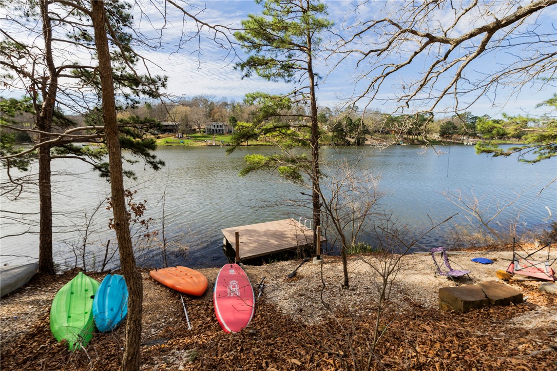 Located on the peaceful shores of Lake Rayburn in Bella Vista, this true lakefront home at 17 Devizis Dr offers an excellent opportunity to enjoy lake living at an affordable price point. The property includes a private dock with direct access to this desirable no-wake lake—ideal for kayaking, fishing, and relaxing on the water.

Inside, the home features vaulted ceilings, exposed beams, and a floor-to-ceiling rock fireplace, offering a classic, retro style with plenty of character. The layout is functional, with a kitchen that includes a peninsula for everyday use.

The seller is offering a $25,000 allowance, providing flexibility for updates and improvements to suit your personal style. Use the money to update the things you would like to update like new flooring or paint...

Whether you’re looking for a weekend retreat, investment property, or a full-time residence, this property presents a great opportunity to own lakefront in Bella Vista.
