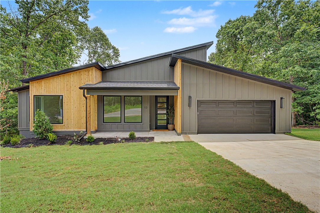 Just completed.  Contemporary style with lots of extras and upgrades. 2 bedrooms ,2 full baths, and an office. Check out the oversized windows allowing lots of natural light into this well laid out, roomy design.Open concept includes living area with an eat-in kitchen.   The chef inspired kitchen features quartz counters,designer textured tile backsplash,waterfall island,upscale lighting and built-in microwave.  The floating shelves and coffee bar or prep station counters add so much to this roomy kitchen.   The master retreat is very roomy and connects to the well-appointed bath with walk-in shower and dual sinks. The walk-in closet has a window for extra lighting. The large covered deck will be a great place to enjoy nature or just relax. The entry mudroom features cubbies for extra storage. The nice sized laundry has a pantry or storage area.  Located close to Loch Lomond Lake and easy access to golf courses, boating ramps, shopping and I-49.  Truly A Cut Above..
