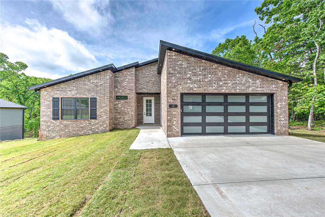 Brand new 3 bedroom, 2 bathroom home with 2-car garage located in desirable Bella Vista, Arkansas. This thoughtfully designed new construction offers an open-concept layout w/luxury vinyl plank flooring throughout the main living areas and a bright, neutral color scheme. The spacious living room flows into the kitchen and dining area, creating an ideal space for entertaining or everyday living.The kitchen features modern cabinetry, stainless steel appliances, ample counter space,& a center island w/ bar seating. The primary suite includes a private en-suite bathroom & generous closet space, while two additional bedrooms are perfect for guests, family, or a home office.Enjoy the peaceful wooded surroundings from the back deck. Additional highlights include a 2-car garage, energy-efficient construction, recessed lighting, and low-maintenance exterior materials. Conveniently located near Bella Vista’s golf courses, lakes, trails,& amenities, this move-in ready home offers comfort, quality,& the Bella Vista lifestyle