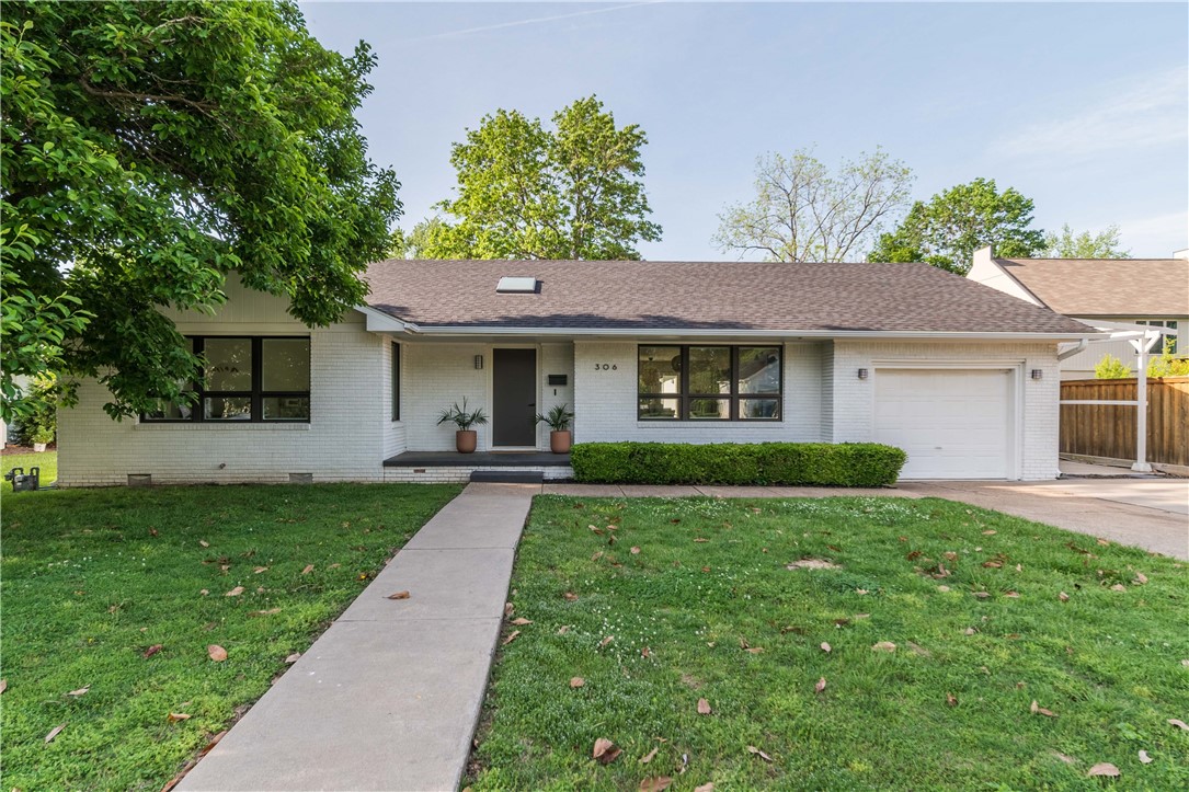 Yes. You can have it all. Check out this gorgeous Mid-Century Modern remodel in the heart of downtown Bentonville. Updates include all-new electrical, plumbing, HVAC, roof and gutters, open-cell foam insulation, drywall, factory-mulled aluminum-clad wood windows, all while preserving the original wood floors in living areas. Touches of elegance include period reclaimed interior doors, poplar trim, two skylights, and a vaulted ceiling in the master. Wow your dinner guests in the all new kitchen with book-matched walnut island, marble countertops, Bertazzoni 5-burner gas stove/oven and Viking fridge. Bathrooms and laundry feature quartz countertops and heated floor in main bath. Garage is insulated, heated and cooled to created a bonus space perfect for a gym, studio, or office. Large lot with driveway easement to back of property is perfect for building a pool, or perhaps an ancillary garage with an AirBnB loft above. Walking distance to the Square, Crystal Bridges, and easy access to the Slaughter Pen MTB trails.