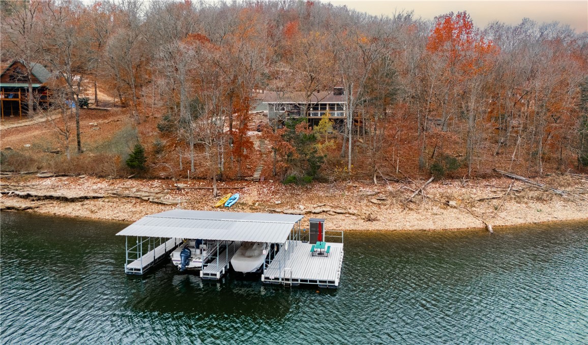 This home, completely remodeled in 2020, offers a fresh and modern living experience just 32 steps from the water. The property features a private dock(with electricity) with two slips and a swim dock, making it a dream for water enthusiasts. Inside, you'll find all new appliances, a new water heater, and updated plumbing and electrical systems. The custom maple cabinets and new flooring add a stylish touch throughout. Whether you're enjoying the waterfront or relaxing in the updated interior, this home is move-in ready and offers the perfect blend of convenience and comfort.