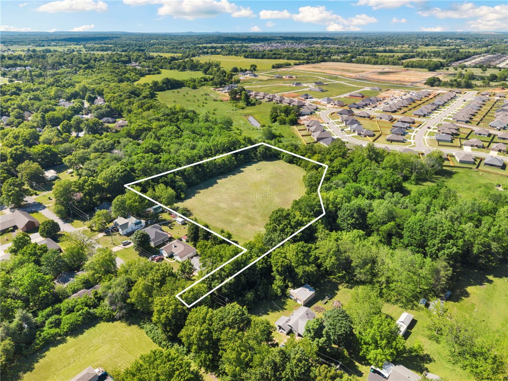 Discover 4.11 acres in one of Farmington's most desirable and convenient locations. Situated just off Main Street, this property offers easy access to schools, shopping, dining, entertainment, and I-49, while still providing a peaceful setting to build your dream home or develop a residential project. Enjoy being within walking distance of Creekside Park and all that Farmington has to offer. Future plans for the Greenway Trail extension are expected to run along the northern boundary of the property, creating direct connections to Mt. Kessler and Centennial Park and adding tremendous recreational value. The land is mostly flat and ready for development, with water and sewer already available on site. Approximately one acre along the rear portion of the property, adjacent to the creek, is located within the floodway. Whether you're a developer, investor, or someone searching for the perfect homesite, opportunities like this in such a prime location are becoming increasingly rare.