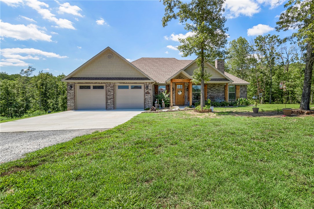 PARADISE FOUND! Sit on your covered deck and watch the deer. Surrounded by 54.4 acres of nature (apprx 40 hardwoods), you'll feel secluded but not far from all NW Arkansas. Many upgrades incl: custom wood cabinets, central vac, NEST thermostat, Generac Whole House generator, LVP flooring, vaulted ceilings & REAL WOOD BURNING FIREPLACE!. Primary suite = 6' jetted & HUGE walk-in shower +his/her vanities. Walk-in closet is bigger than most bedrooms + has a private office next to it. Huge covered patio/deck allows you to enjoy the nature of your backyard in privacy. The 50x80 red iron barn is fully insulated & has complete RV hookups w/a 23' center. A 750 sf cabin is built into the barn w/full kitchen, bathroom, living & sleeping area. The barn has it's own well & septic system + has 220V & 50 amp hookup & wood burning stove. Privacy but not far from all, here's your homestead. Tontitown-6 miles, Siloam-4 miles, XNA-15 minutes, Bentonville/Fayetteville-20 minutes.  Also listed as MLS #1299251 & MLS #1299252
