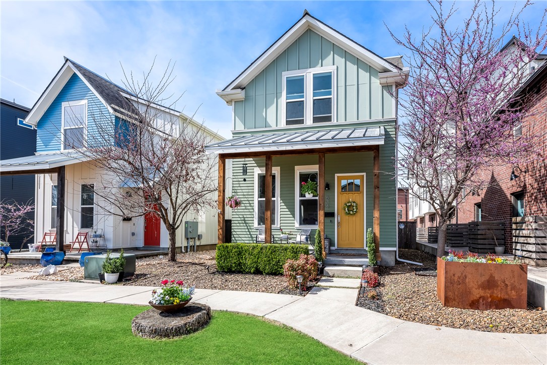 Enjoy the ease and energy of downtown Bentonville living in this charming Craftsman-style row home just blocks from the Square. Walk to restaurants, coffee shops, trails, and local events while coming home to a space that feels both stylish and comfortable. The interior is filled with natural light, high ceilings, and an open layout designed for everyday living and entertaining. A cozy fireplace with custom built-ins anchors the main living area, while the open kitchen features a large breakfast island, gas range, and generous pantry. The main level includes a full bath and a flexible bedroom—ideal for guests or a home office. Upstairs, two private bedroom suites offer walk-in closets and ensuite baths, plus a bonus living area perfect for relaxing or working from home. Outside, enjoy an expanded patio with a wood-burning fireplace and cedar pergola. A full-size, two-car detached garage completes this downtown retreat.