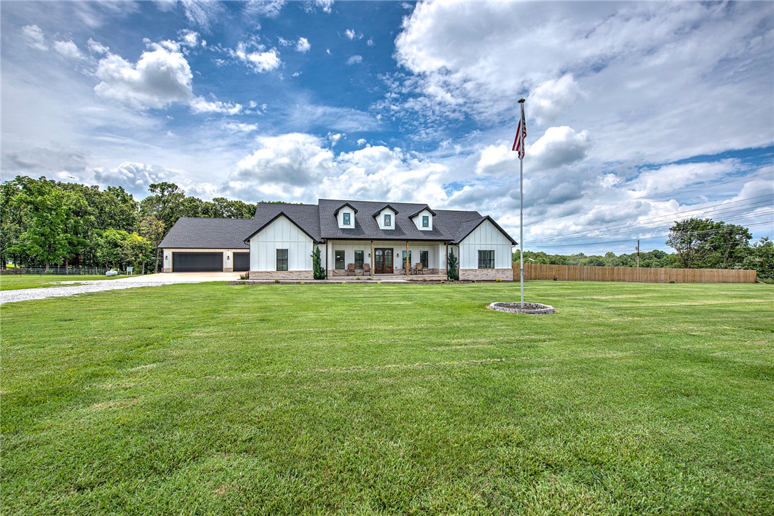 Welcome to this stunning modern farmhouse built in 2021, perfectly situated on 4 peaceful acres in the countryside. Combining timeless farmhouse charm with contemporary design, this exceptional property offers space, comfort, and luxury. Step onto the inviting front porch and into a beautifully designed home featuring 5 spacious bedrooms, an expansive living room with abundant natural light, a modern chef’s kitchen complete with high-end finishes, ample cabinetry, and generous entertaining space. Designed for relaxation and functionality, the home also features a covered back porch overlooking the scenic acreage — perfect for adding an in-ground pool and pool house! Car enthusiasts, hobbyists, or those needing extra storage will appreciate the impressive 6-car garage offering endless possibilities for vehicles, equipment, workshop, or recreational space. Surrounded by open countryside yet thoughtfully designed for modern living, this amazing property offers the ideal balance of privacy, luxury, and rural charm.