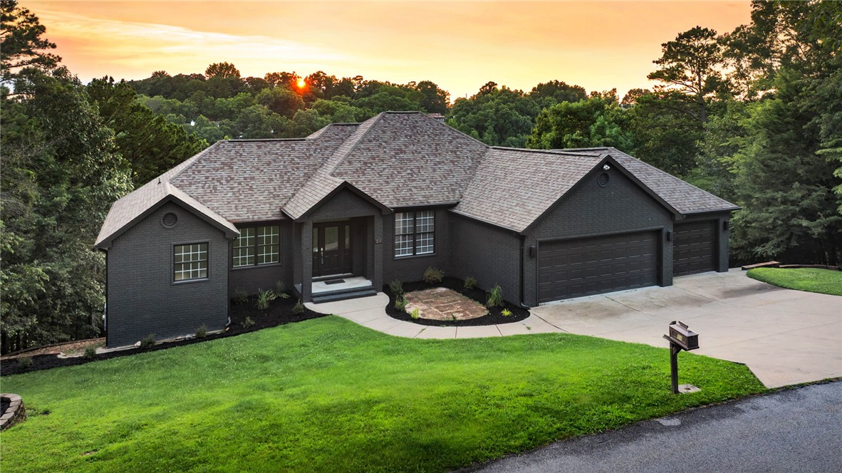 Move-in ready lake retreat on beautiful Beaver Lake. Set on a quiet cove, this recently updated home offers lake views, walk-to-the-water access, and a community dock with a 28 foot boat slip and community swim deck. Inside, you’ll find thoughtful updates including Cafe appliances, tiled bathroom showers, new high-end lighting fixtures, and stylish finishes that give the home a fresh, elevated feel. The walk-out basement adds flexible living space, with two screened patios overlooking the lake, creating the perfect place to relax, dine, or entertain while enjoying the view. New frameless glass shower door, mirrors, and landscaping in front will be installed before closing, adding another polished touch. All furniture,TVs,& appliances convey, making this an easy turnkey opportunity! Ready for immediate enjoyment, this Lake property combines comfort, convenience, and the peaceful lifestyle of lake living. BONUS:1% preferred Lender Credit! Less than 10 minutes to Downtown Rogers!  NO HOA. Has never been an AirBNB.
