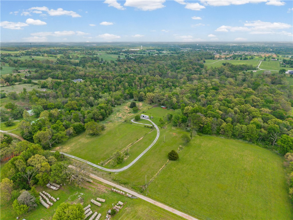 Additional 5-acre tract also available for full 10 acres, see MLS 1343300 for all photos and more info...  Enjoy peaceful living on this beautiful 5-acre property tucked away at the end of a quiet dead-end road just minutes from Gravette. This tract offers a great mix of open space and natural surroundings, with level areas ideal for building and scenic west-facing sunset views. Electric is already on site, and a water meter has been paid for and is ready to be installed, with water available at the property. A perc test has been completed, making it ready for septic installation. Accessed via a gravel driveway easement, with some existing wire fencing. Enjoy a relaxed rural setting just 7 minutes to downtown Gravette, 30 minutes to Bentonville and Pinnacle Hills, 13 minutes to I-49, and 32 minutes to Walmart Home Office. Additional 5-acre tract available for full 10 acres.