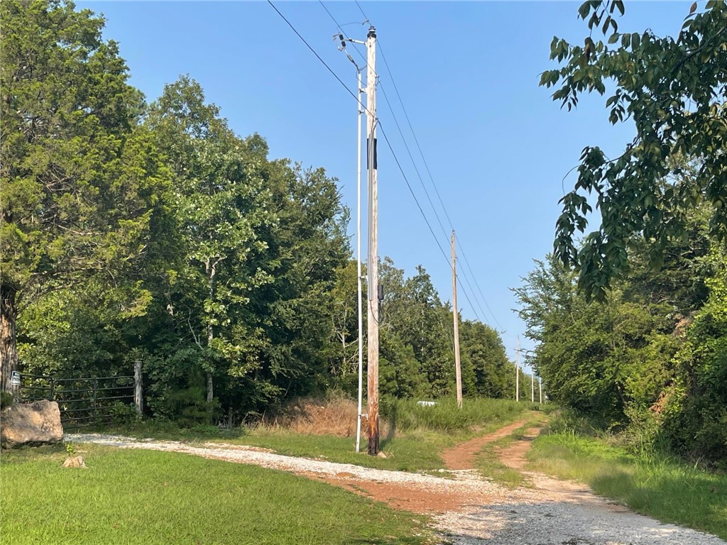 CAN BE SPLIT INTO 5 AC & 6.1 AC. Within 5 minutes of downtown Prairie Grove, this 11.1 MOL acres is located on a flat hilltop, partially cleared and surrounded by trees with plenty of privacy. This property is close to electric, fiberoptic and public water at the street. Come and take a look. There is potential to build, develop a few lots, or just to have some wooded land for recreational use. Property is already surveyed into 2 separate lots but has not been recorded with the county. Motivated sellers!