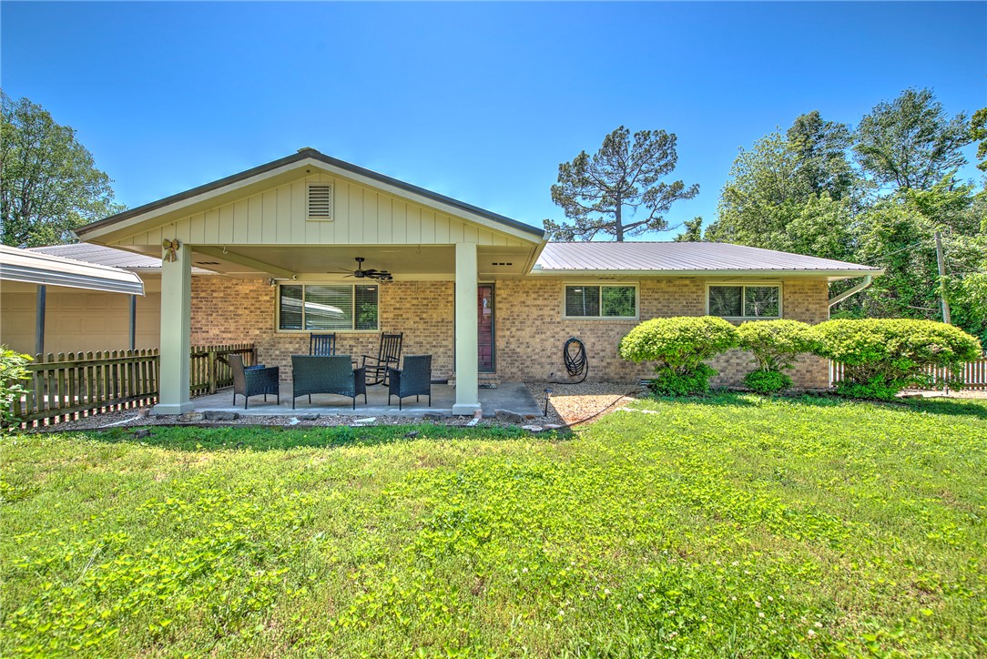 Turn-key charm meets everyday comfort in this beautifully updated ranch-style home designed for the way you live. The seamless kitchen and dining layout creates an effortless flow for both entertaining and daily life, while the cozy second living area is anchored by a wood-burning insert that adds warmth and character. Situated on a spacious corner lot, the property offers exceptional outdoor space with a large backyard, charming picket fence, and a 60 SF storage building perfect for tools, seasonal decor, or outdoor gear. In addition to the garage, two large covered carports provide abundant covered parking and flexible space for recreational vehicles, boats, or extra storage needs. Covered front & back porches create inviting spaces to relax & unwind year-round. Conveniently located near schools, office parks, shopping, parks, and nearby bike trails, this home blends comfort, functionality & location in one inviting package. Furniture negotiable- ready to move in or a perfect investment property ready to go.