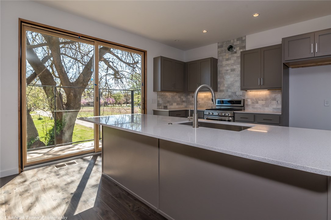 Located in the Northwest Quadrant of Downtown Bentonville, this Modern 3 story house is a must see property.  The house includes 3 bedrooms, 1 1/2 baths, 2 car garage that is alley loaded, high end appliances, quartz counter tops, fenced in yard, next thermostat system and modern landscaping.  The large master bedroom is an oasis in itself.