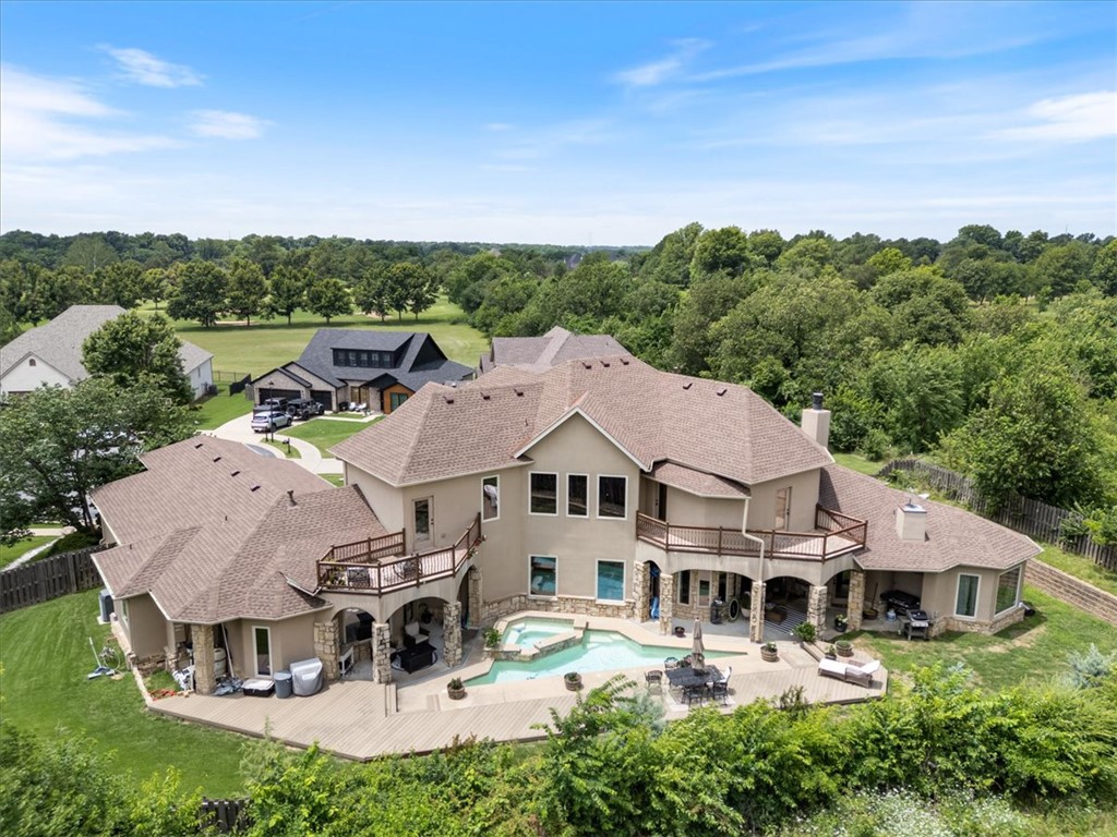 Centrally located NWA Estate Property located a couple minutes from I-49 and Elm Springs Rd.  Gorgeous European style Custom Built home featuring a private backyard with resort spa like saltwater pool with composite decking.  Beautiful hardwood floors, built-in's throughout the home with incredible woodwork and iron balusters for stairs and interior balcony.  Kitchen comes complete with large walk-in pantry, Jenn Air Appliances, Double Oven, Gas Cooktop, Two Sinks, Large Island, built-in Fridge and Custom Cabinetry. Private office room with french doors and half bath.   Master suite with adjacent nursery room. All secondary bedrooms with private bathrooms. Covered patios and balcony porches overlooking the pool.   Many updated home systems/finishes include new roof (2025), new Dishwasher (2025), new on demand tankless water heater (2025), New Pool Heater, Projector/Speakers and mixer in theatre room, Exterior stone work, irrigation system installed and french drains and new trees.