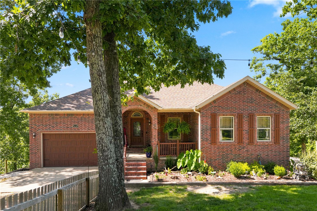 This beautifully renovated 3,321 sq foot home offers space, privacy, and lake living on 2.56 acres directly across from Beaver Lake. A tree-lined approach creates a quiet, secluded setting with occasional lake views. Inside, updates include refinished hardwood floors, fresh interior and exterior paint, and updated lighting throughout. The main level features three bedrooms and two full baths, including a fully remodeled primary suite. The kitchen offers new appliances and a functional layout for everyday living and entertaining. The lower level includes a spacious bonus area with a mini kitchen, pool table space, and 75-inch TV, plus a theater room with Polk Audio, full bath, and flex room. LVP flooring for the downstairs has been purchased but not installed. A 30x60 insulated shop with three 12x12 doors, LED lighting, ample electric, and 35 AMP camper hookups adds exceptional versatility.