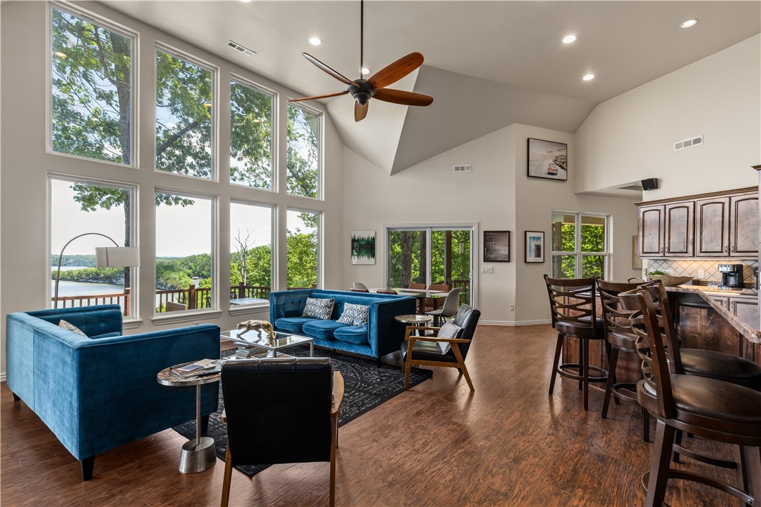 Imagine waking up every morning to panoramic views of Beaver Lake from every room in your home — then checking your VRBO income while guests enjoy the same experience. This fully furnished, off-grid-capable lakefront retreat sits on 9.3 secluded acres with 750 feet of private shoreline, making it one of NW Arkansas's most compelling live-in or investment properties. The custom-built home features soaring 14-foot cathedral ceilings, granite counters, and a split floor plan where all three bedrooms open directly onto a sweeping deck above the water. An 8-person sauna, hot tub, and fire pit keep guests coming back — and the reviews show it. With owned solar panels, a private well, and battery storage, your overhead stays low while your rental appeal stays high. Additional building sites offer room to expand with cabins or a shop. Whether you're seeking a legacy property, a high-performing short-term rental, or both — this estate delivers.