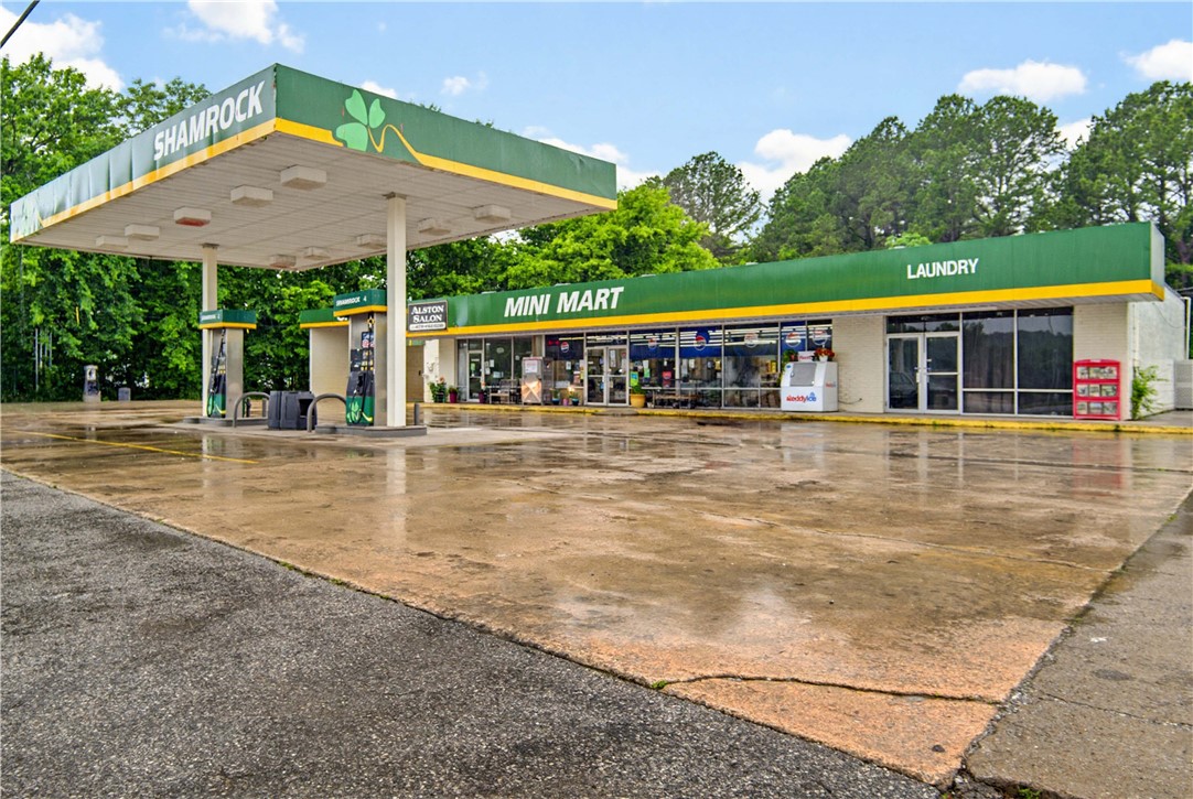 ***Public Auction: Friday August 28th @ 10a.m.*** Prime commercial investment opportunity in the growing community of Greenland! Property features 260'+ of Hwy 71 frontage on highly traveled corridor directly across from Greenland High School. This well-established property offers exceptional visibility & a diverse mix of income-producing businesses. The property features a convenience store w/t working gas pumps, a laundromat & self-service car wash (needs updating & equipment), & an additional commercial lease space, creating multiple sources of rental & business income under one roof. Conveniently situated 5 miles from the UofA & just over a mile to I-49, the location benefits from steady traffic generated by local residents, commuters, students, and visitors. The laundromat & car wash present an excellent opportunity for modernization, allowing a new owner to increase revenue while adding long-term value to the investment. Expand your portfolio & bid on a property w/t immediate cash flow & growth potential.