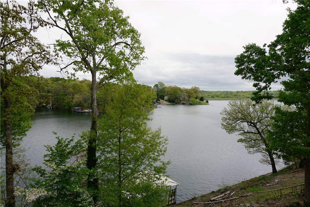 Spectacular view of Lake Loch Lomond! You'll never want to leave your deck with views like these. House has been totally remodeled. Updates include flooring, fixtures, windows, roof, heat & air system, solid surface counters in kitchen, granite counters in bathrooms, 4 solar tubes, vinyl siding, gutter-guard guttering, seawall, and covered boat dock w/lift. HVAC has special filtering for allergies. Huge 26x10 screened deck & beautiful professional landscaping. This is a little slice of paradise. MUST SEE!