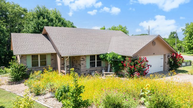 Welcome to your private retreat in the desirable Highlands area of Bella Vista! This beautifully maintained move-in-ready home features stylish luxury vinyl plank flooring and sits on a level corner lot surrounded by mature trees, offering exceptional privacy and a peaceful natural setting. Relax or entertain on the spacious covered deck, then unwind in the hot tub while enjoying the serene surroundings. Extra parking provides room for guests, bikes, or recreational vehicles. Bonus: The adjacent vacant Lot #9 is included in the asking price (addl 0.32 acres), providing added privacy, expanded outdoor space, or future possibilities. Ideally located less than a mile from the world-famous Tunnel Vision bike trail and minutes from Lake Loch Lomond, golf courses, and outdoor recreation. Enjoy quick access to the new Bella Vista Bypass for an easy commute to the new Walmart Home Office in Bentonville. Schedule your private showing today!