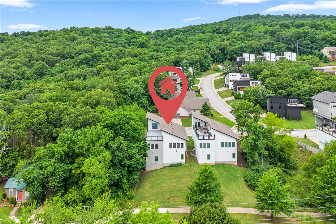 You found it. The one. Tucked inside Fayetteville's Treetops subdivision, 204 S Forest Canyon Ave is the 2023-built contemporary you didn't know you needed — three levels, 2,450 square feet, and more style than you can handle. We're talking quartz counters, hardwood floors, a gas fireplace, smart home tech, and a kitchen built for Sunday brunches and weeknight wine nights. Three bedrooms, two and a half baths, a 2-car garage, and wired sound because of course. But the location? That's the real flex. Minutes from downtown Fayetteville, a quick drive to the U of A, and practically in the backyard of the Mt. Sequoyah trails. You're hiking before coffee and at Dickson Street by dinner.  — and yes, your friends are already jealous.