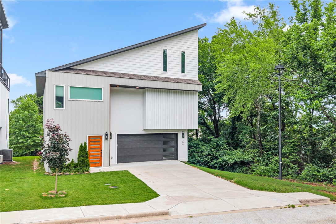 You found it. The one. Tucked inside Fayetteville's Treetops subdivision, 204 S Forest Canyon Ave is the 2023-built contemporary you didn't know you needed — three levels, 2,450 square feet, and more style than you can handle. We're talking quartz counters, hardwood floors, a gas fireplace, smart home tech, and a kitchen built for Sunday brunches and weeknight wine nights. Three bedrooms, two and a half baths, a 2-car garage, and wired sound because of course. But the location? That's the real flex. Minutes from downtown Fayetteville, a quick drive to the U of A, and practically in the backyard of the Mt. Sequoyah trails. You're hiking before coffee and at Dickson Street by dinner.  — and yes, your friends are already jealous.