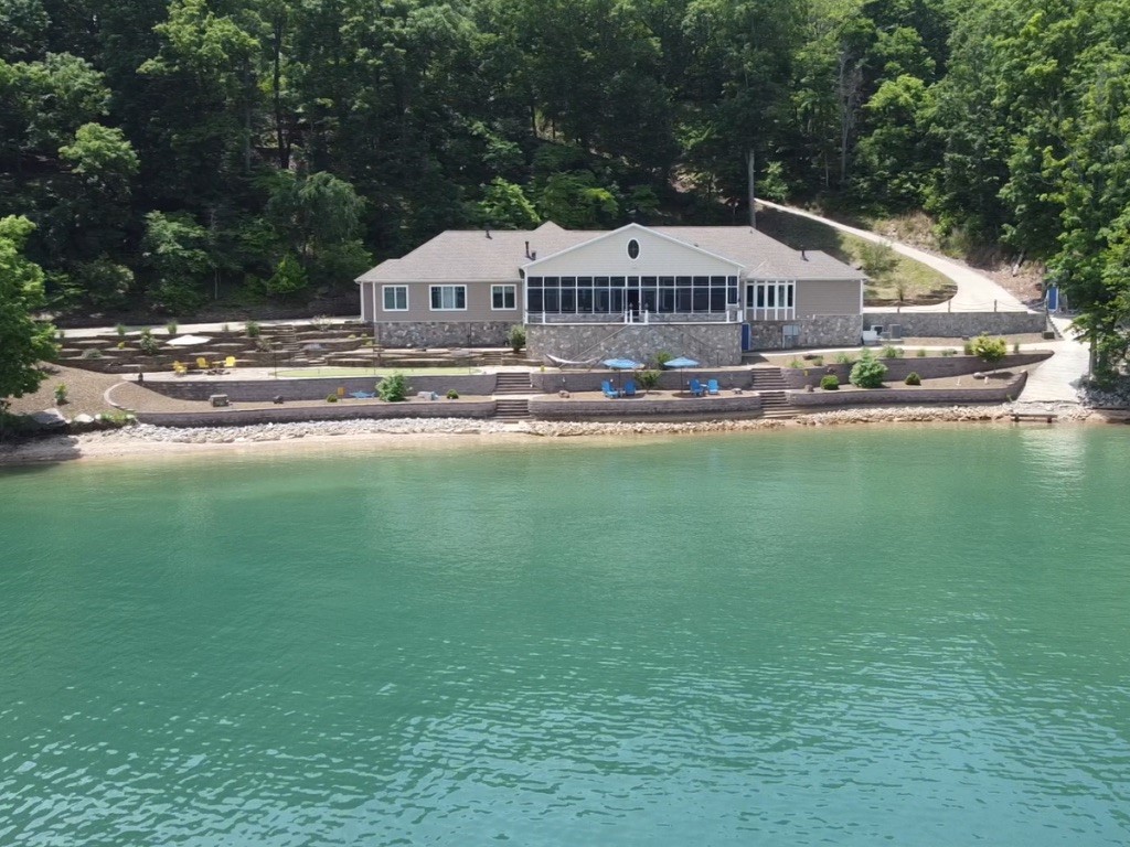 Rare opportunity to own a custom built waterfront home on Beaver lake on 3.62 acres with easy access to the water. Included is an additional 5.21 acre buildable lot with a newly refinished private boat dock. Features include a concrete reinforced 700+ bottle climate controlled wine cellar / safe room. a large John Deere storage room, custom lighting and ironwork, Large Walk in pantry. The second bedroom doubles as an office with built in Murphy bed. The Owners suite offers a spa like experience with heated floors and walk in shower. Oversized two car garage with shop and storage room. Enjoy the whole house automation and entertain in large screened in galley and living area. The property boasts a professionally landscaped low maintenance yard that include bocce ball court, fire pit and breathtaking views.       Additional 5.21 acres Parcel #18-00239-001