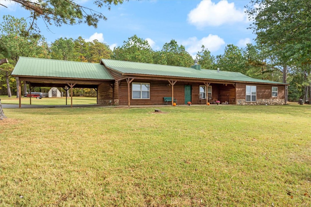 The custom log-siding home is 4,000 square feet under the roof and 2,380 square feet heated and cooled. The home has 2 fireplaces, one built with cobblestone from Utah and the other with cobblestone from Colorado. It is a 3-bedroom, 2-bath home with a huge master bedroom featuring a fireplace and lights you can control without getting out of bed. The master bath has a huge tub, a shower, and his-and-hers toilets. The primary bedroom has his-and-hers walk-in closets. It has a formal living room and a den with lots of wood siding on the inside. Invite people over to enjoy the 20x20 party porch, and if you love horses and rodeos, host your own in the 300x150ft rodeo area located by the house. The 40x60 shop with electric and water service offers space for tools, boats, and side-by-sides, and also has an RV hookup. Located behind the shop is a 40x60 pad for extending the existing shop building. The property is perfect for having horses or running a small cattle operation, and is a hay-producing piece of land.
