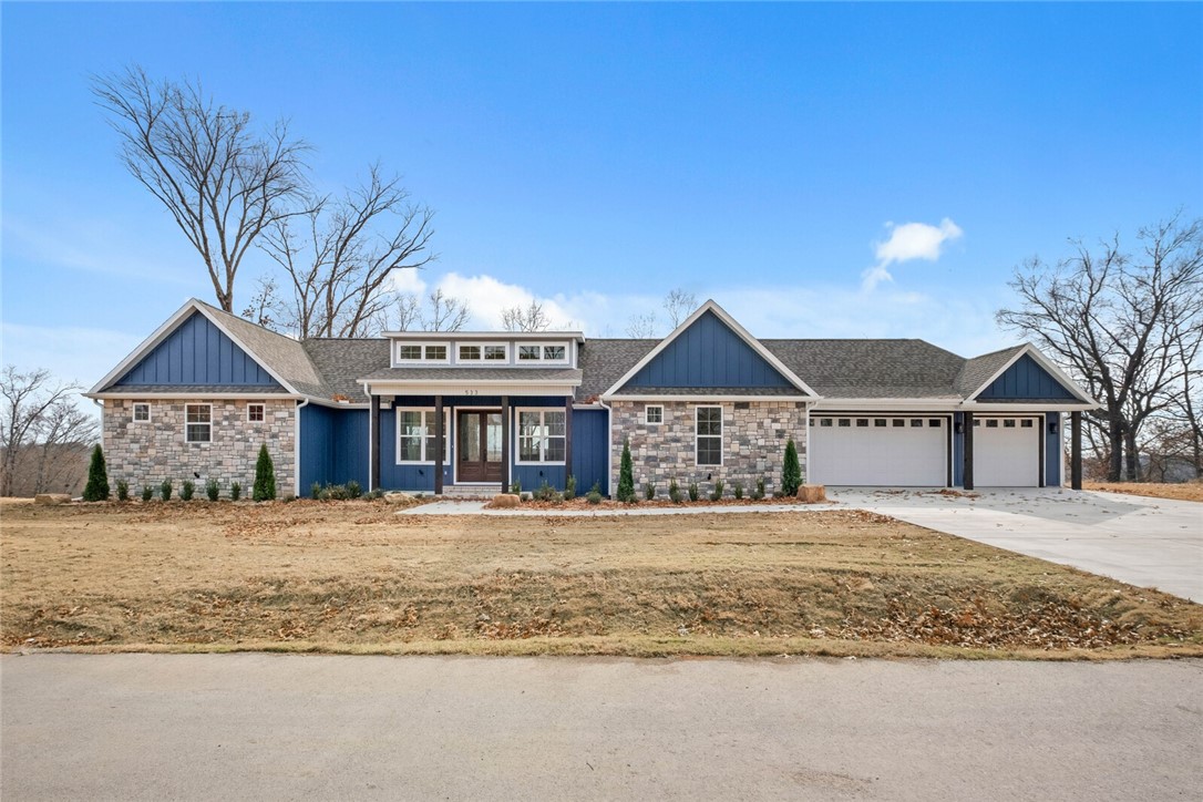 Looking for a quite, wooded neighborhood? Shelby Forrest is the place to be. This custom built home overlooks Big Sugar valley and golf course. Featuring an open floor plan with soaring living room ceilings, a chefs dream kitchen, massive covered deck, a second living room, office, tons of custom finishes and lots of windows and extra storage, oversized 3 car garage, all hardwood flooring and so much more. Just minutes from Downtown Pea Ridge and Downtown Rogers. Be at Beaver Lake in 15 minutes and downtown Bentonville in 15 minutes.
