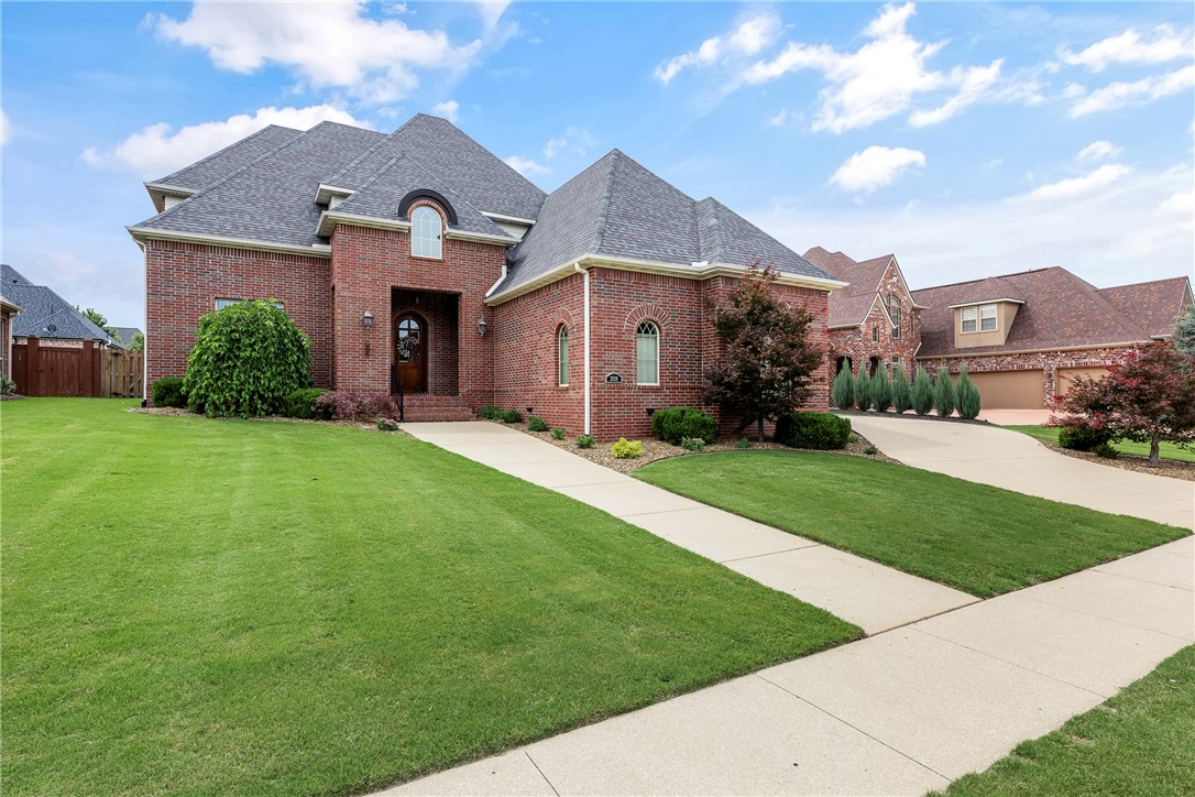 Welcome to this beautiful brick home in the desired Turnberry at the Peaks subdivision. You will love the spacious rooms & the warm feeling you get when you enter the elegant foyer. Classic architectural details such as arched doorways, high ceilings, large windows, hardwood floors, crown molding, neutral paint & granite finishes throughout adds to the feel of this traditional home. The large living room with gas fireplace & cabinetry is open to the kitchen with new stainless steel appliance suite, island bar and eating area that leads out to the covered back patio, creating great spaces for family and friends to gather. The formal dining room & second living area, along with the primary suite, additional full guest bath, split plan second bedroom and the large laundry room, round out the well designed floor plan, so all living can be on one level if needed. Upstairs are two additional bedrooms with Jack-n-Jill bath plus accessible attic storage. Schedule your tour today - don't miss this opportunity!!