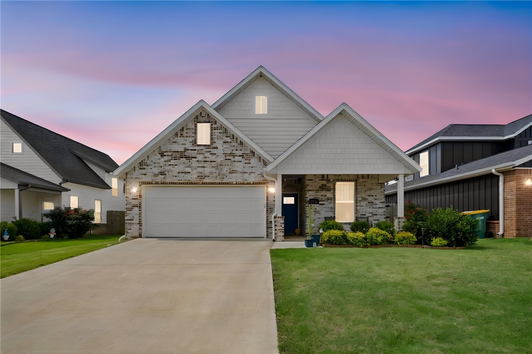Welcome to this beautifully designed modern home in the desirable Grove subdivision of Rogers! Offering 4 bedrooms, 2.5 bathrooms, and approximately 1,950 sq. ft., this thoughtfully designed floor plan features an open-concept living area perfect for entertaining and everyday living. The spacious kitchen boasts granite countertops, stainless steel appliances, a pantry, a breakfast bar, and abundant cabinet space. Rich wood flooring, stylish finishes, and plenty of natural light create a warm and inviting atmosphere throughout. The primary suite offers a relaxing retreat with a large walk-in closet, double vanity, soaking tub, and separate walk-in shower. Enjoy outdoor living in the fully fenced backyard with a covered patio, ideal for gatherings or quiet evenings at home. Conveniently located near shopping, dining, schools, parks, hospitals, and walking and biking trails, this home combines comfort, style, and an unbeatable Rogers location.