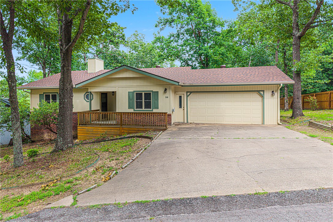 Tucked into one of Bella Vista's most sought-after neighborhoods, this charming all-brick, 3-bedroom, 2.5-bath home sits on nearly half an acre and checks every box. The spacious living room anchors the main floor, and the kitchen features a dishwasher and plenty of prep space. Step outside to your screened deck — the perfect spot for morning coffee or evening wind-downs — plus an additional open deck for entertaining. A standout bonus: a 10x18 workshop tucked neatly under the home, ideal for hobbies, projects, or extra storage. The cozy gas log fireplace, walk-in closets, skylight, and wood floors add warmth and character throughout. The fully fenced backyard offers privacy, and with trails, parks, and the Bella Vista POA amenities — including a pool, clubhouse, tennis courts, and Loch Lomond lake access — practically in your backyard, the lifestyle here is hard to beat. With a 2-car attached garage and low $40/month POA fee, this one is a true gem.