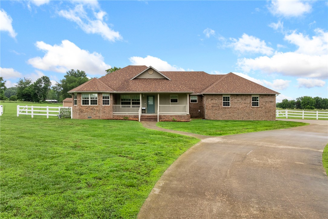 This beautiful 3-bedroom, 2-bath brick home on 1.14 acres m/l is loaded with quality features and updates! This well-maintained property offers real oak hardwood flooring, custom kitchen cabinetry, and a cozy gas fireplace that creates a warm and inviting living space. The spacious primary suite features a relaxing Jacuzzi tub. Enjoy peace of mind with a new roof installed in 2023, a full-house Generac generator, whole-house water treatment system, storm shelter, and two brand-new water heaters installed in 2025. The home also includes a 2-car garage, covered back porch, and a storage shed for additional space and convenience. Step outside to a fully fenced backyard and enjoy your covered patio! With numerous upgrades and thoughtful features throughout, this move-in ready home offers comfort, functionality, and security. This home is a true must see! Schedule your private showing today before this exceptional property is gone!