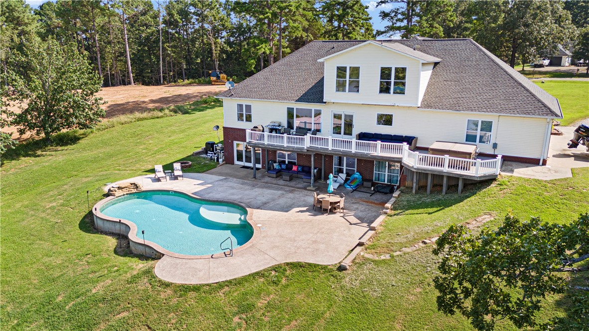 POWERFUL PRESENCE--stunning, cliff top dwelling overlooking the Arkansas River! CUSTOM BUILT home offers sweeping views, waterfront ambience, and golden sunsets. Well-designed aesthetics have maximized its location as a water front domain. Main level offers huge windows and new flooring throughout. Formal dining room, additional coffee bar, massive office with built ins, well-designed kitchen w/ bar, 1 of 2 living rooms are also on main level. Exceptional view of the water from the primary suite--offers a room that is the walk in closet plus an extremely spacious bathroom. Downstairs offers a huge living room plus game/exercise room, bedroom, laundry room, bonus rooms. Walk out to the self-cleaning, saltwater pool with water fall. Extra pavilion for entertaining.