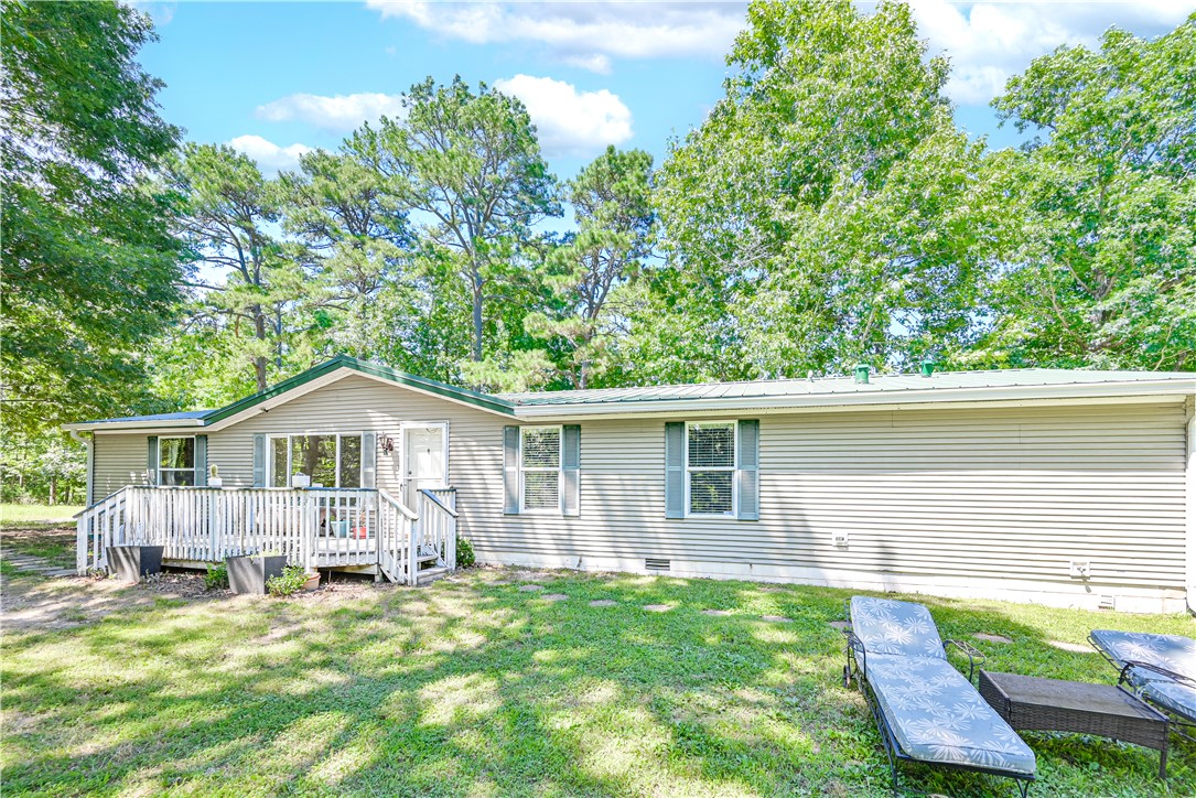 If you have been craving space, privacy, and a place that feels tucked away from the noise, 17942 Railroad Cut Rd may be exactly what you have been waiting for. Sitting on 8.5 private acres just minutes from Hobbs State Park, Beaver Lake, and War Eagle, this 3-bedroom, 2-bath home offers room to live, work, create, and breathe. The home is on a permanent foundation and features a metal roof, two living areas, a 2-car attached garage, and a downstairs workspace connected to the garage. Outside, you will find front and back porches, a fenced backyard for pets or animals, and an additional building that could be used as a shop, studio, workspace, or extra storage. Whether you want a peaceful personal retreat, room for projects, or simply more land around you, this property offers a lifestyle that is becoming harder and harder to find in NWA.