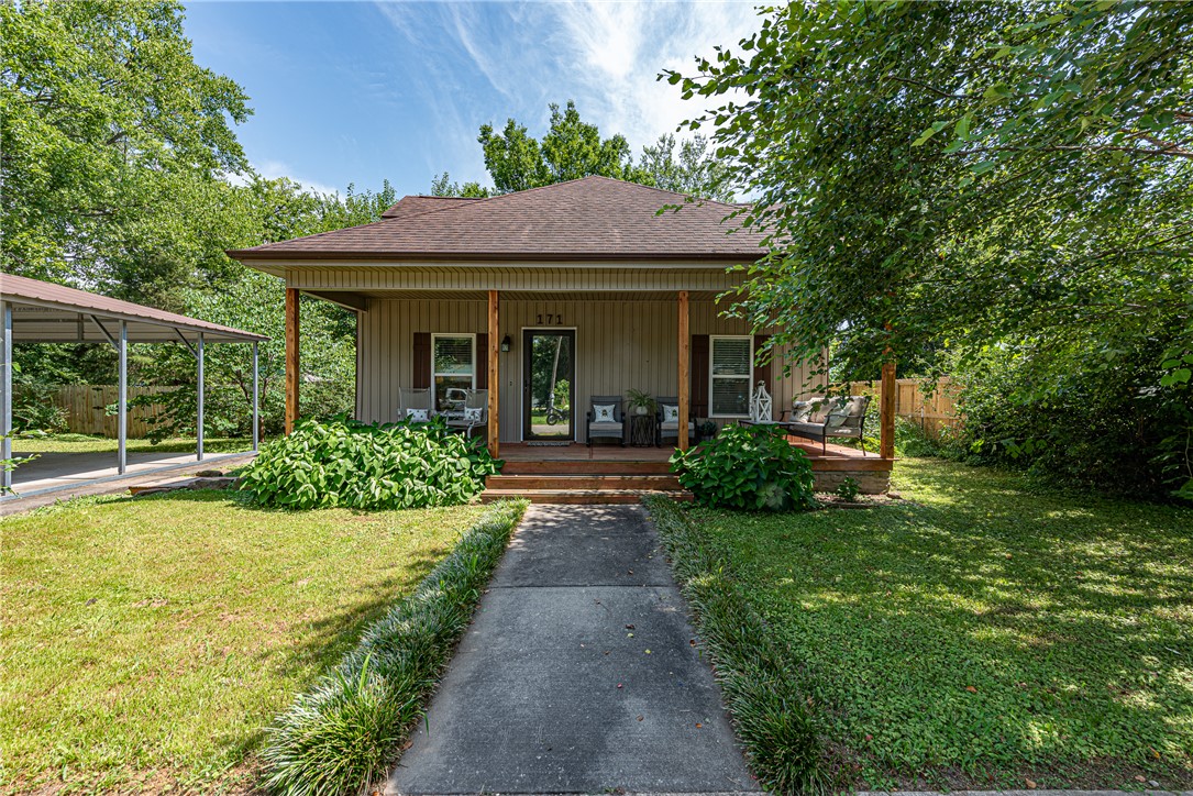 WELCOME HOME! Fully remodeled in 2019 this 3 bedrm 2.5 bathrm home in Downtown West Fork is within walking distance of grocery, library, Opry House & Riverside Park! Less than 30 min to Devils Den State Park, Lake Fort Smith, & Downtown Fayetteville! From the covered front porch head inside to open concept space w/ spacious living room feat: LVP flooring & dining area! Large L-shaped kitchen w/ shaker-style cabinets, granite counters, tiled backsplash, & island peninsula! Split floor plan w/ main floor primary bedrm & ensuite feat: Double sink vanity & shower! Upstairs enjoy a loft space w/ built-in bench & addt'l  two bedrms & a full bathrm! Out back enjoy an oasis with mtn views feat: fence, spacious deck, raised garden beds, storage bldg w/ roll-up door, lean-to covered storage, pergola, hot tub, blackberry bushes, & fruiting mulberry tree! Property also incl 3 car carport & addt'l room for trailers, RVs, with drive-through gate w/ removable walkway panels for backyard access! Don’t miss out on this opportunity!