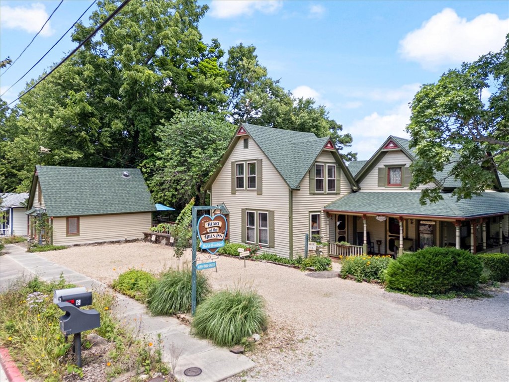 Want to move to a little victorian village in the Ozark mountains and open up a Bed and Breakfast? This is your day dream calling you to Northwest Arkansas. Heart of the Hills Inn and Cottages, circa 1883, is centrally located on the upper historic loop just a few blocks from the Crescent Hotel and a short 3 block stroll to all downtown Eureka Springs has to offer for both full time residence and short term visitors alike. This property is multi faceted and can lend itself to suit many different styles and or family sizes. If the plan is to soft retire and it is just one or two Inn keepers or if you need more personal space and want the entire main house for your private residence and you only want to keep the cottage as a nightly rental, this property can provide both a large single family residence and a completely separate cottage providing a great source of passive income for a comfortable and exciting "next chapter" in life. Beaver Lake & Table Rock Lake are about a half hour & XNA is less than an hours drive