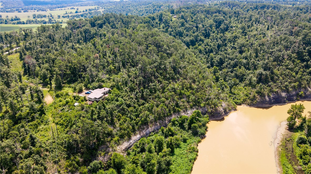 Overlooking the War Eagle River, this remarkable property offers sweeping views, private river access, and world-class fishing—all within a community steeped in history and cultural significance. Just across the river from the iconic War Eagle Mill, this 20?±?acre estate invites you to experience nature at its finest. Deer and eagles are frequent visitors, and the air feels as pure as the scenery looks. Inside, the home exudes warmth and comfort—the kind of cozy atmosphere you’d expect to find in a classic film or a Hemingway novel. Spacious bedrooms, inviting living areas perfect for entertaining, and a peaceful quiet make every moment here feel restorative. For those seeking adventure, opportunities abound: enjoy direct river access, spend days exploring the Mill property, hike the trails of Hobbs State Park, or take a short drive to Beaver Lake. Come discover all that awaits at 11375?High?Sky?Inn?Road—a place where nature, history, and serenity meet.