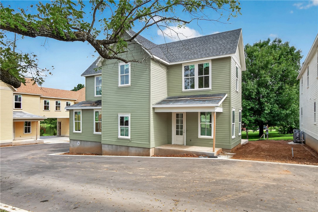 Welcome to Smyth Crossing – where history, community, and thoughtful design meet in East Fayetteville’s coveted Crossover area. Born from a vision to preserve the cherished home of immigrant Peter Smyth, this neighborhood blends heritage with modern living. Tree-lined streets, green spaces, and timeless architecture create a place to connect and celebrate the Ozarks’ beauty. Among its standout homes, The Prow House combines charm, function, and versatility. It features 4 beds, 2.5 baths in the main home- plus versatile room & 1-bath above the garage, perfect for guests or extended family. A welcoming front porch and private courtyard offer inviting spots for morning coffee or evening tea, while the open floor plan inside flows effortlessly for entertaining and everyday living. Luxury finishes and an efficient layout make this home as stylish as it is comfortable. Minutes from top schools, parks, trails, and shopping. More than a neighborhood, it’s a living tribute where legacies are honored and new stories begin.