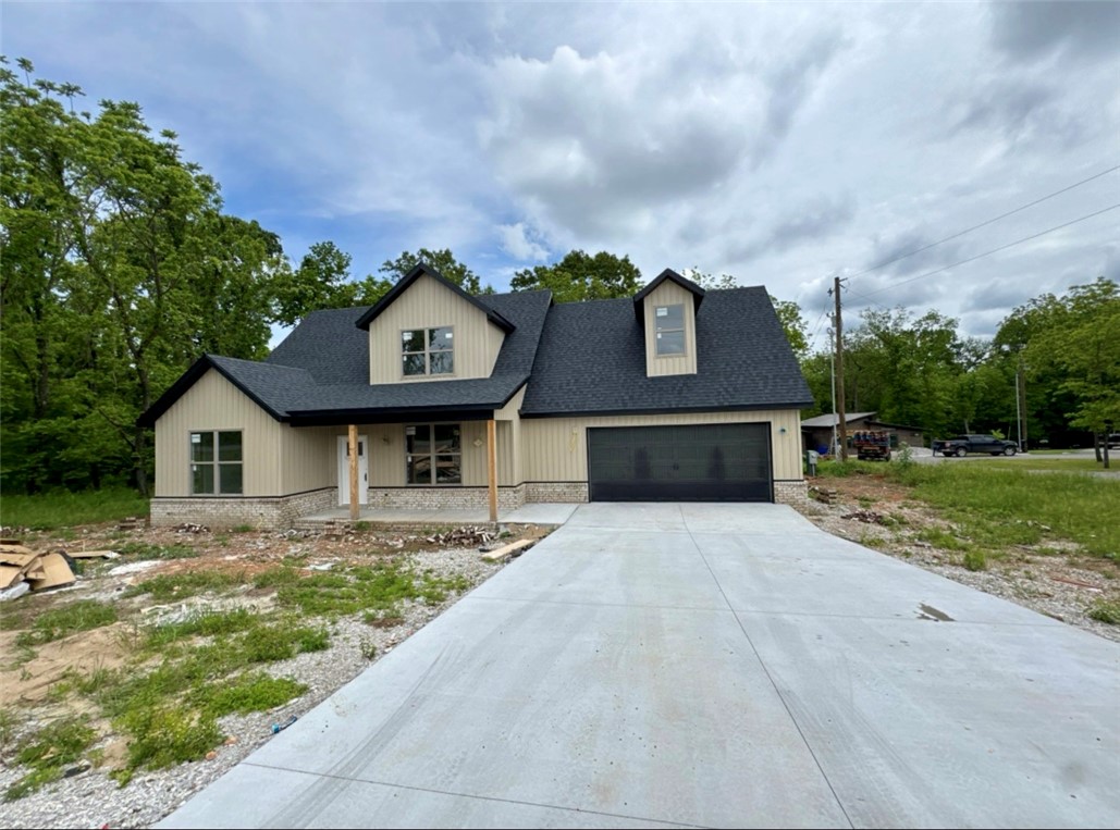 Corner Lot in a Fantastic location— easy access to I-49 & Highlands Golf Course. This 2 level NEW home is sure to please with Primary Suite on the main level featuring dual varieties, custom tile shower, free standing tub, & WIC. Open concept living area with engineered hardwood floors, abundant natural lighting, & gas log fireplace. Spacious Kitchen with stainless steel appliances (separate glass cooktop & wall mounted oven), sink has window to view of the FLAT backyard. Upstairs has 1 bedroom with WIC, Hollywood style full bath, & LARGE media room/hobby room. Covered Deck & pre-wired for a whole home Generator! Enjoy Nature, Golf courses, community pools, club houses, lakes, trails, & gun range (all are included within Bella Vista’s Community Amenities). 100% $0 down payment financing is available, ask for details. Targeted Completion Date: June 1st!
