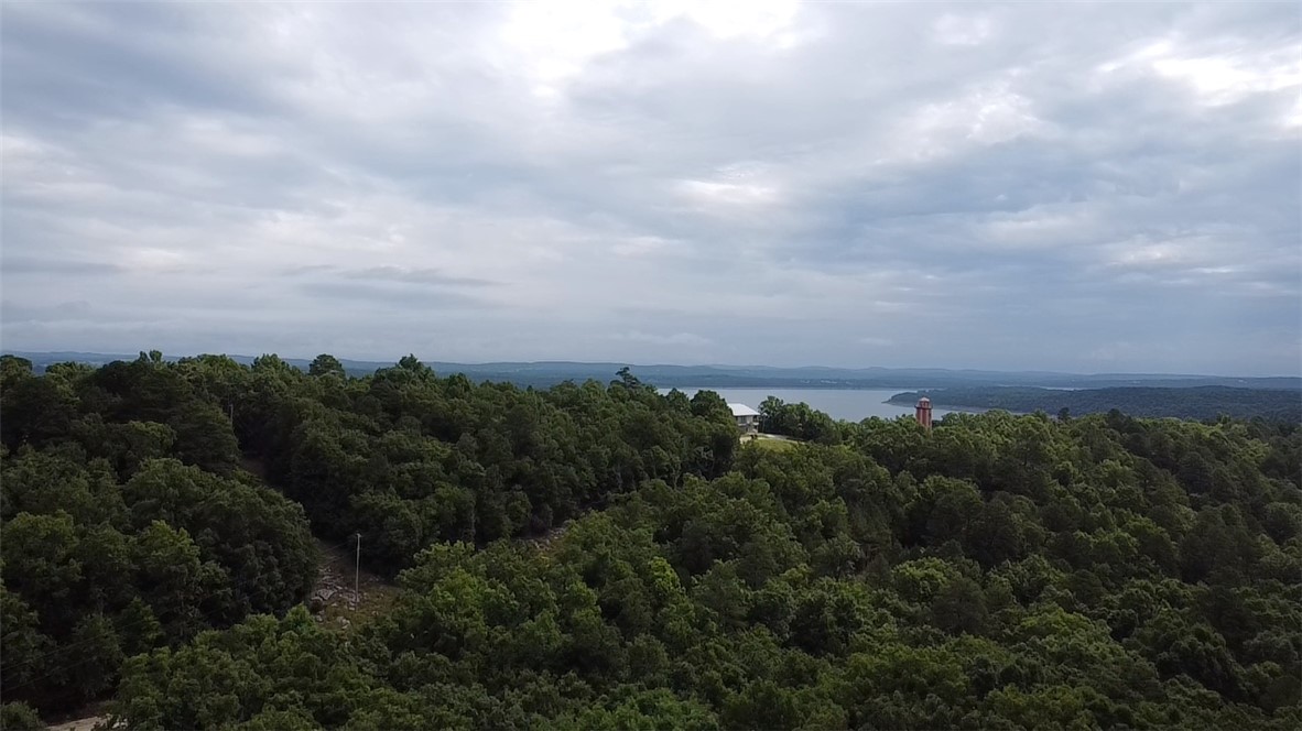 Enjoy country living on 18.91 acres m/l with a distant view of Bull Shoals Lake! Located at 400 MC 2032, Yellville, AR, this 4-bedroom, 3-bath home offers plenty of space along with a study/office that could also be used for additional storage. The property includes a detached 24' x 52' workshop with an attached 2-car garage, offering excellent potential for a guest house, hobby space, home business, or additional living quarters. A rare opportunity to own acreage, lake views, and versatile outbuildings in the Ozarks.