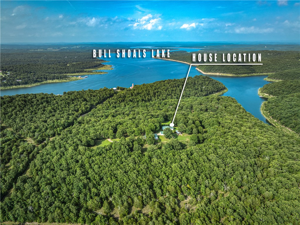 Enjoy country living on 18.91 acres m/l with a distant view of Bull Shoals Lake! Located at 400 MC 2032, Yellville, AR, this 4-bedroom, 3-bath home offers plenty of space along with a study/office that could also be used for additional storage. The property includes a detached 24' x 52' workshop with an attached 2-car garage, offering excellent potential for a guest house, hobby space, home business, or additional living quarters. A rare opportunity to own acreage, lake views, and versatile outbuildings in the Ozarks.