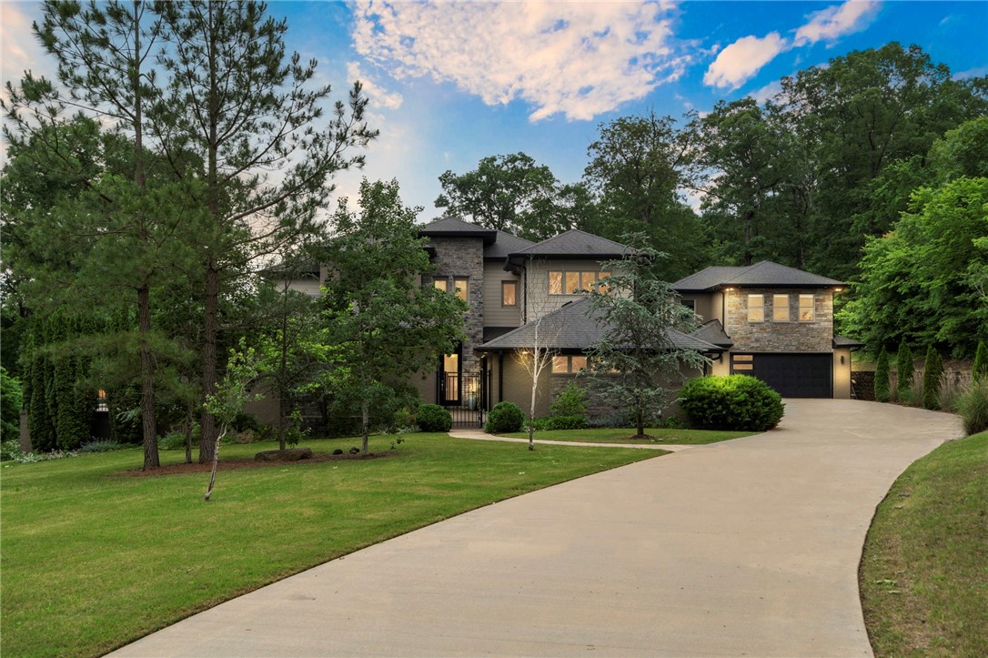 Luxury Living Estate, perfect for those who value space, privacy, nature, style and luxe amenities. This expansive property offers a flexible layout ideal for families, entrepreneurs, creatives, or anyone seeking both luxury and utility. In addition to the 5,091 sq ft in the main house, a detached 810 sq ft creative studio above the garage offers full independence—ideal for guests, older kids, extended stays, creative projects, or executive use. The main living area boasts soaring ceilings & an open flow, perfect for hosting or relaxing in style. A professional-grade kitchen w/ premium appliances & a 6-burner gas range is built to support both daily life and large-scale entertaining. Natural light fills the home w/huge windows throughout. The primary suite includes a spa-style bath, dual vanities, soaking tub, and walk-in shower, creating a private retreat within the home. Step outside to enjoy your own Outdoor Oasis w/ full kitchen, heated pool w/fountains, covered cabana & 5-car garage. Has been pre-appraised!