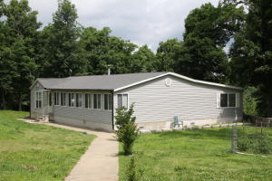 Great 3 bedroom 2 bath manufactured home on 15.92 acres. Home features spacious kitchen & dining area, wood burning fireplace, sunroom, plus an enclosed porch with extra kitchen. Paved driveway, outbuildings, and beautiful views. See Supplements for more information.