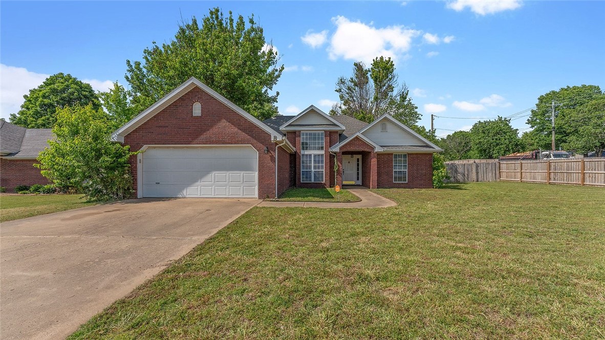 Gorgeous all brick home sitting on a large corner lot with an oversized fenced backyard with covered large deck and great outdoor entertaining area with firepit to relax and enjoy family time. Location is exceptional as only minutes from I-49, University of Arkansas, shopping, restaurants and schools. An inviting large living room with elevated ceiling allows plenty of space to sprawl. The dining room off the front door could easily be repuposed as a flex space, play room or an home office. The kitchen features plenty of countertops, cabinets, pantry and a breakfast nook with french doors to the backyard with tons of windows beaming natural light throughout etire living space. Split floorplan with two bedrooms for the kids and a bathroom with skylight with the primary bedroom with an ensuite on opposite side of the home. The fenced backyard has plenty of room for the kids and pets to safely play, blackberry garden and 2 storage sheds for your outdoor gear. Refrigerator, washer and dryer will convey with the home.