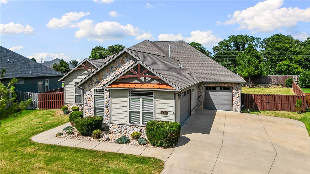 Welcome to 3760 Bitterroot, where style and convenience come together in the heart of Northwest Arkansas. This spacious 4-bedroom home with a dedicated office offers an open-concept layout featuring a stunning stone fireplace and a chef's kitchen complete with custom cabinetry, a pot filler, walk-in pantry, and ample counter space. The private primary suite boasts a huge walk-in closet and luxurious ensuite bath. You'll also appreciate the convenient laundry room with built-in lockers, a north-facing covered patio, fenced backyard with irrigation, and an oversized 3-car garage. Energy-efficient upgrades include a tankless water heater, radiant barrier roof sheathing, and LP SmartSide siding. Conveniently located just minutes from I-49, shopping, dining, schools, and everything Northwest Arkansas has to offer.