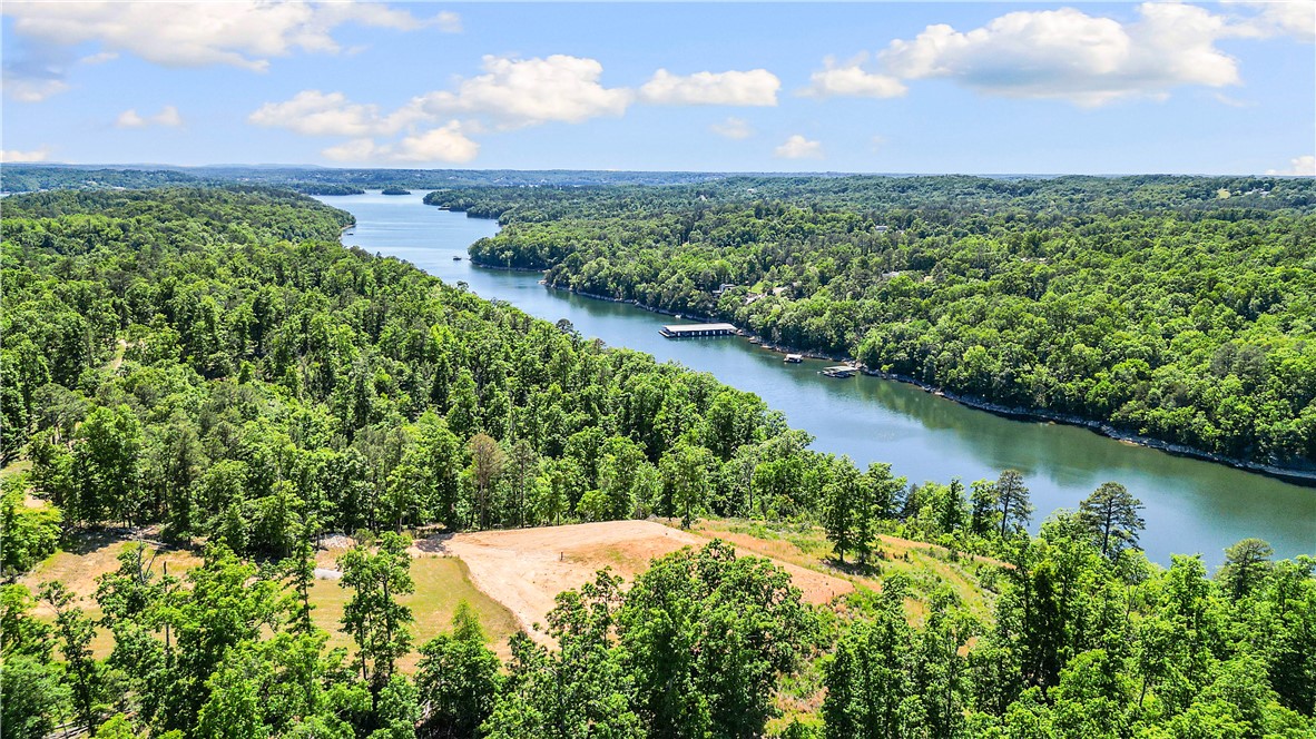 Discover the perfect blend of privacy, luxury potential, and natural beauty with this 17.1-acre lake view and lake front property overlooking Ventris Cove on Beaver Lake. Offering endless possibilities, this rare piece of land is ready for your dream home or future retreat. A future home pad measuring 113’ x 80’ has already been designed to support an approx. 6,800 sq. ft. structure, giving you a head start on creating a custom lake property tailored to your vision. The groundwork is already in place with a drilled water well at 618’ depth, along with a septic system installed and permitted for a 3-bedroom home up to 4,000 sqft, with the ability to be extended for a larger home if desired. Whether you’re looking to build a full-time residence, luxury getaway, or investment property, this land offers seclusion, relaxation and lake front breathtaking panoramic views of Ventris Cove and Beaver Lake.